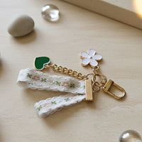 Decorative keychain with floral elements on a wooden surface