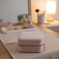 Pink jewelry box on a table with a blurred background