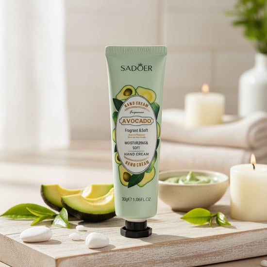 Hand cream with avocado ingredients on a wooden board with avocados and candles in the background