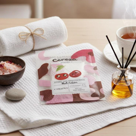 Ceremonial tea set with a tea bag, cup, and tea leaves on a wooden table.